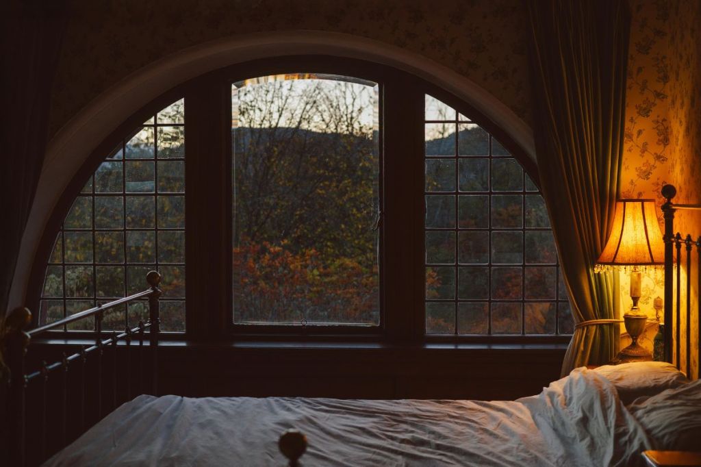 Warm bedside lamp in a dim bedroom